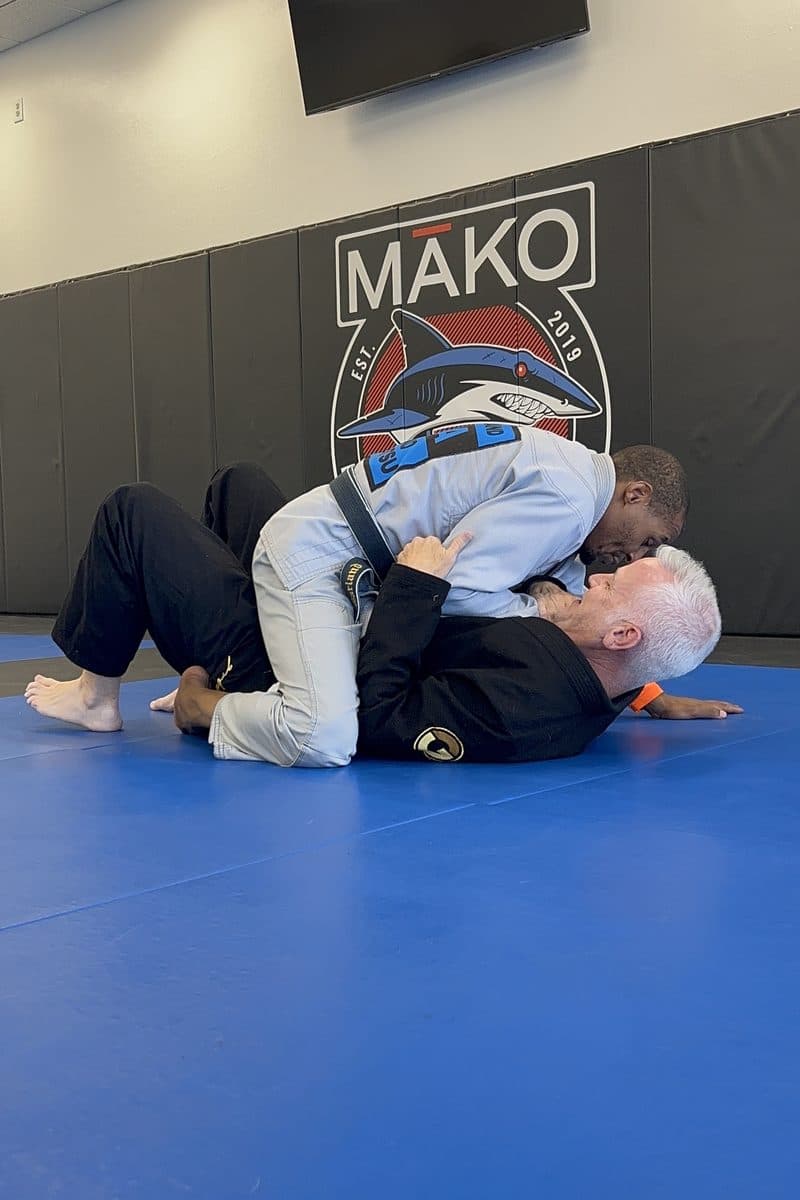 An officer drilling a guard pass with a training partner