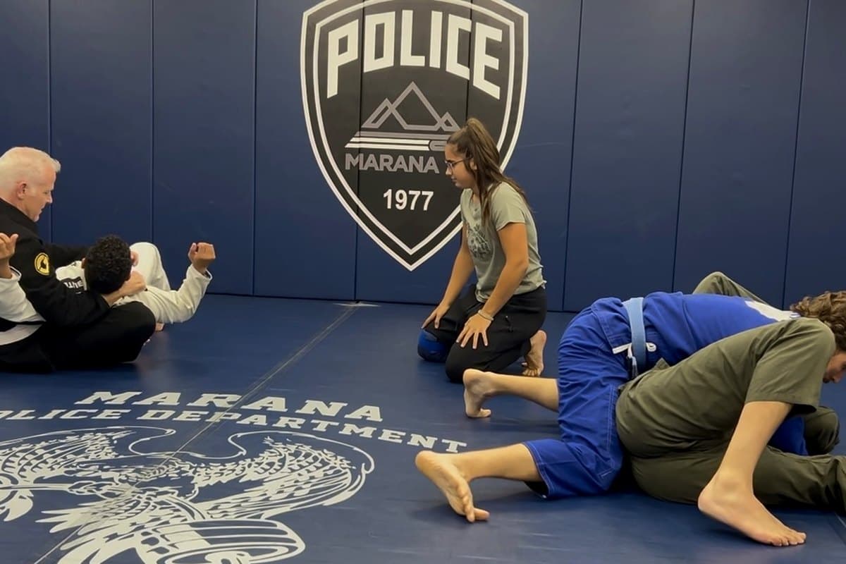 Officers training on the mats of the Marana Police Department gym